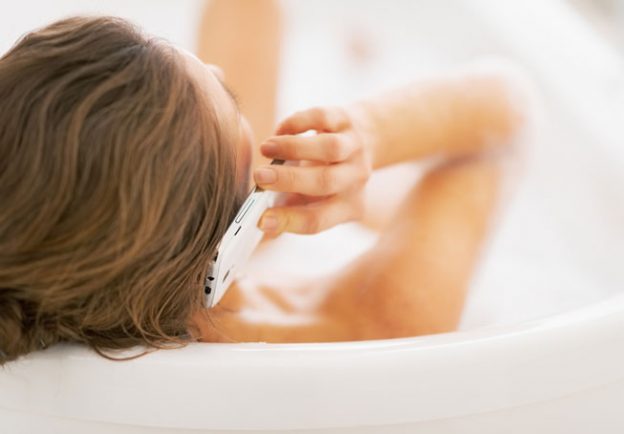 Woman taking a hot bath while calling her favorite dating chatline on Valentines Day