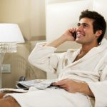 Man in robe dating on the phone