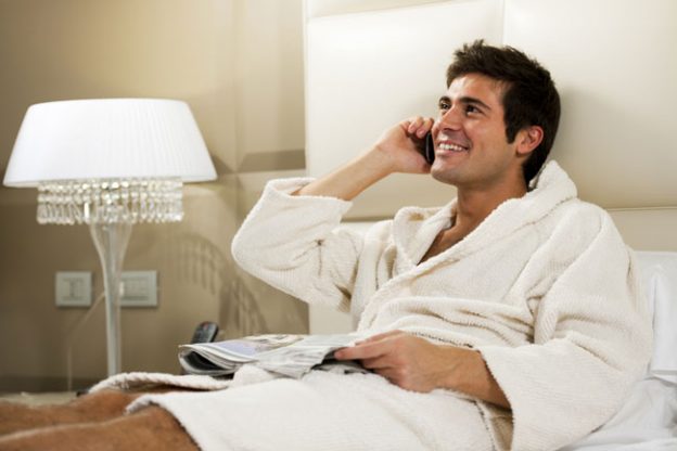 Man in robe dating on the phone