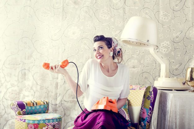 Vintage housewife chatting on the phone in hair salon