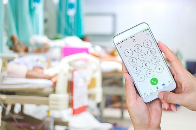 Calling chatline in front of HIV positive patient in hospital bed