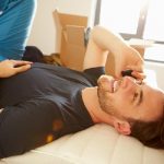 Attractive male lying down while talking into his mobile phone